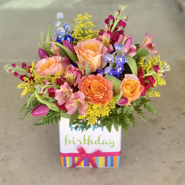 Mixed bouquet in a birthday gift box with roses and colorful blooms