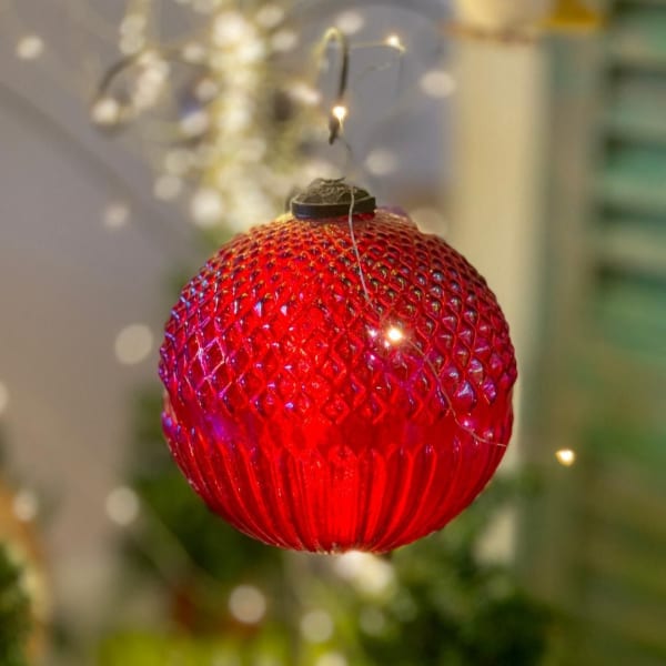 Red glass Christmas ornament hanging by a wire
