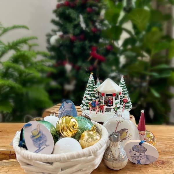 Christmas ornaments and figurines arranged on a wooden table