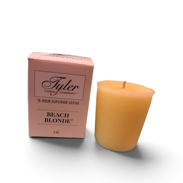 Pink boxed votive candle beside a yellow candle