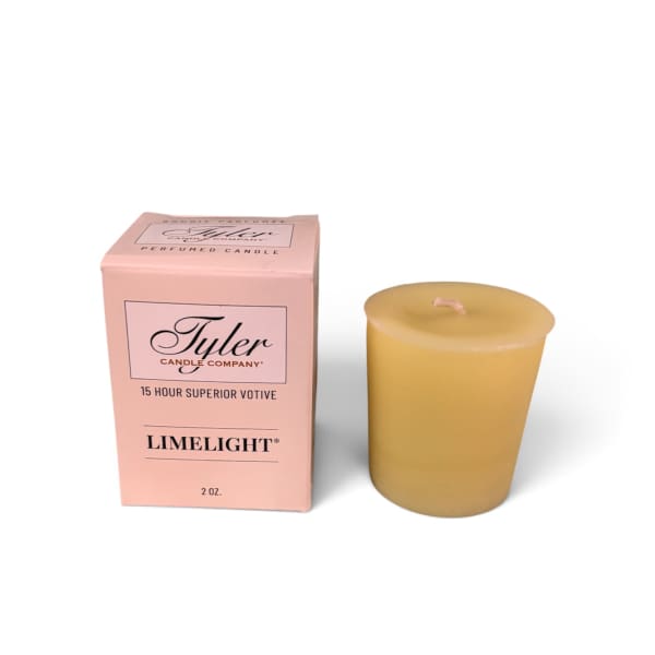 Pink boxed votive candle beside a yellow candle