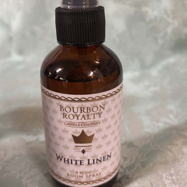 Amber bottle of White Linen room spray with a black pump top