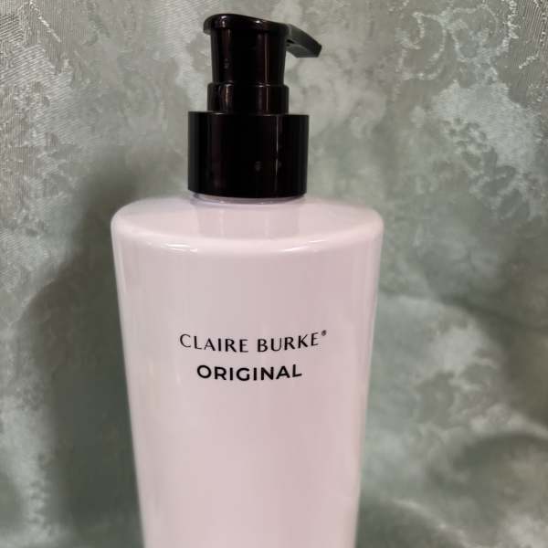 Pink body lotion bottle with a black pump dispenser