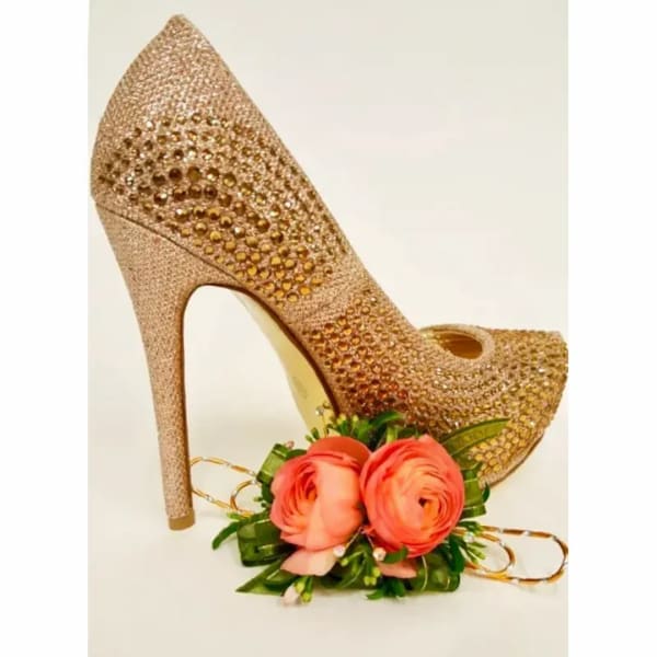 Gold high-heel shoe with coral flowers at the toe