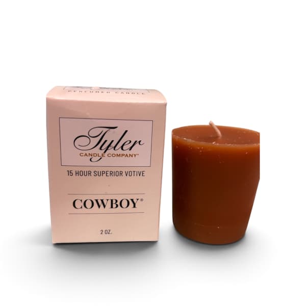 Brown votive candle beside a pink Tyler Candle Company box