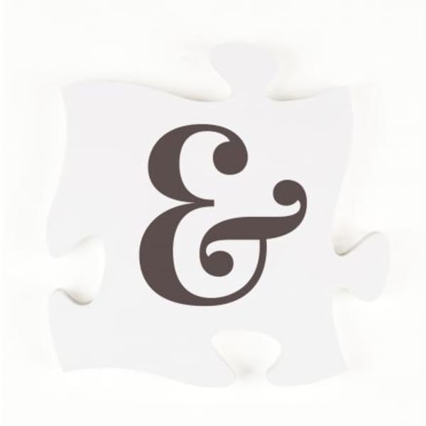 White puzzle piece with a dark ampersand symbol