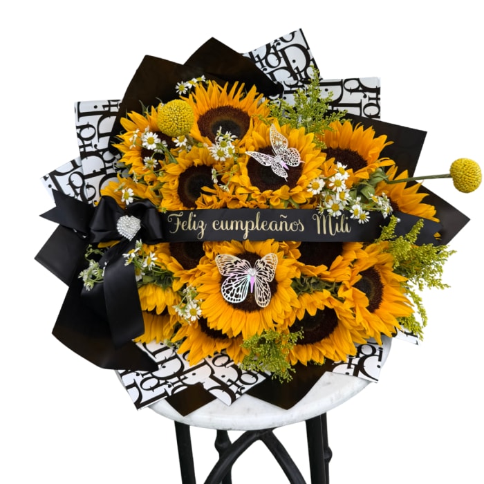 Sunflower bouquet with black wrapping and a birthday ribbon