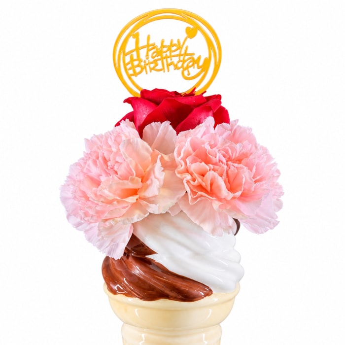 Pink carnations and a red rose in an ice cream cone vase with a birthday topper
