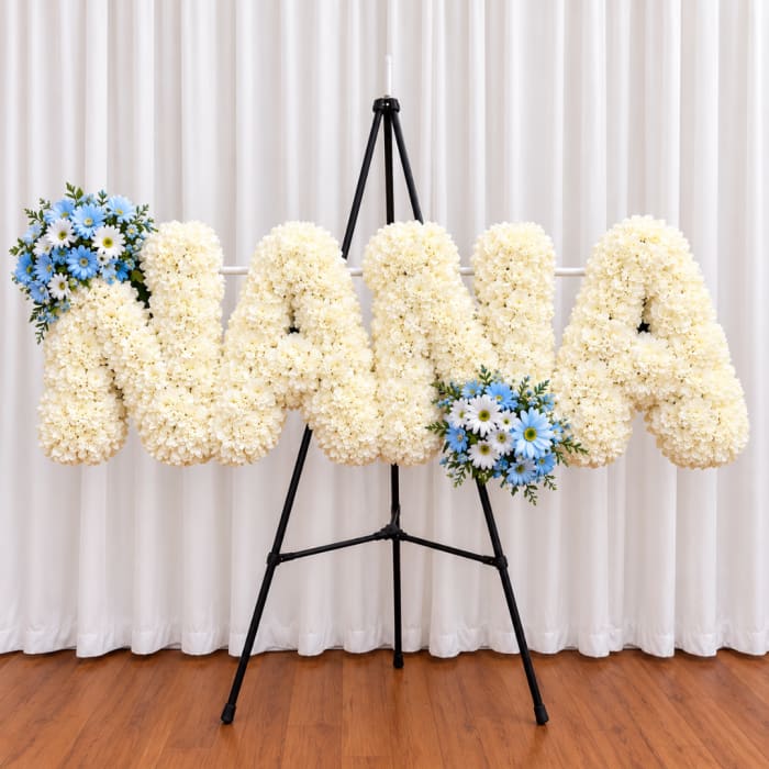 Cream floral letters on a stand with blue daisy accents