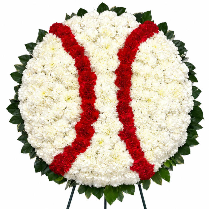 Round floral wreath with white and red chrysanthemums on a stand