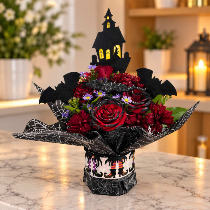 Halloween bouquet of red roses with a haunted house topper