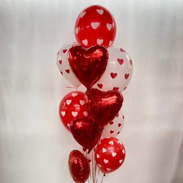 Cluster of red and white heart-shaped balloons tied together