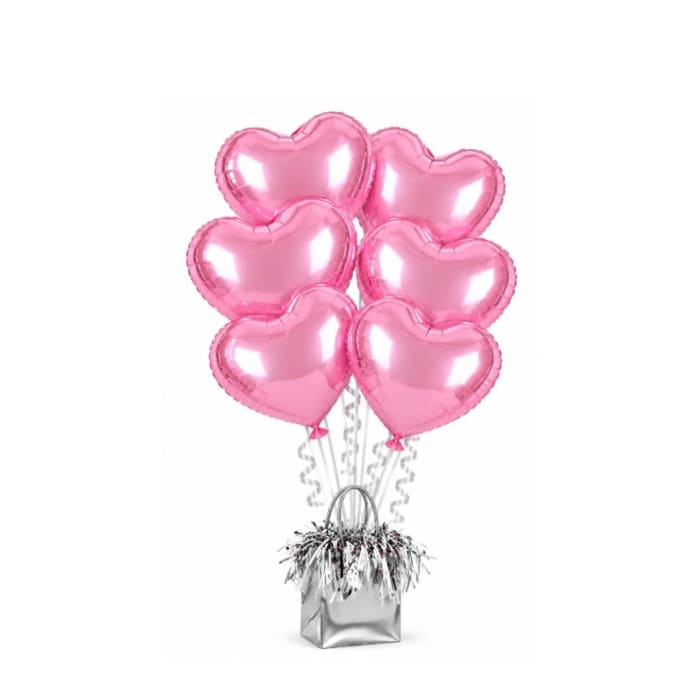 Pink heart-shaped balloons in a silver gift bag with curly ribbons