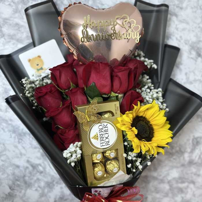 Bouquet of red roses with a sunflower, chocolates, and a heart balloon