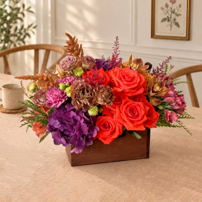 Colorful flower arrangement in a wooden box on a table