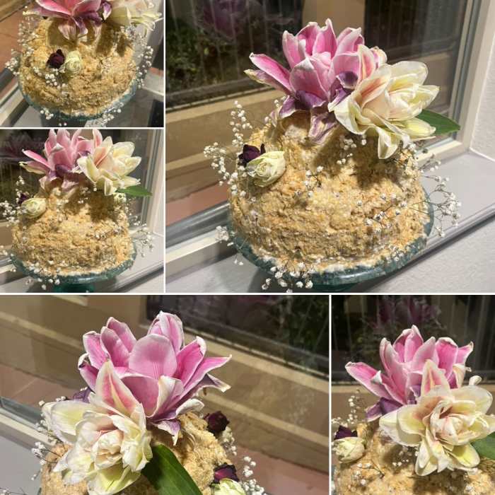 Tiered cake with pink and white flowers on top
