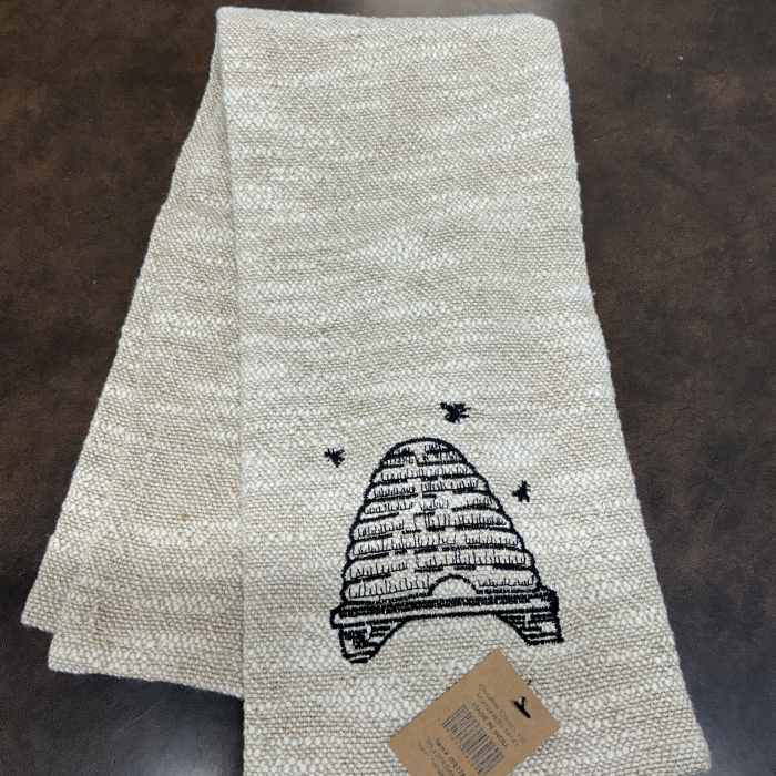 Folded woven table runner with a black beehive design