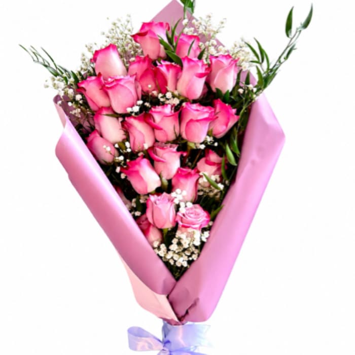 Pink rose bouquet wrapped in pink paper with a lavender ribbon