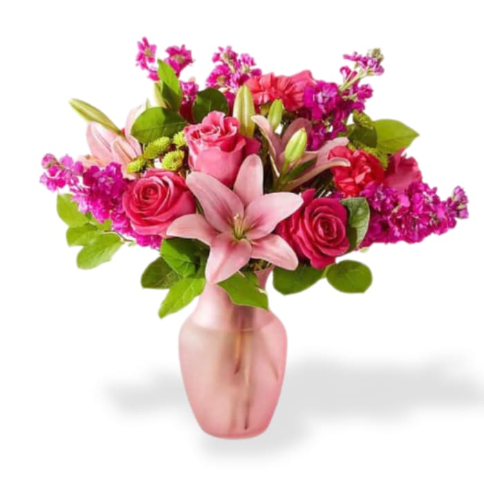 Pink roses and lilies arranged in a pink vase