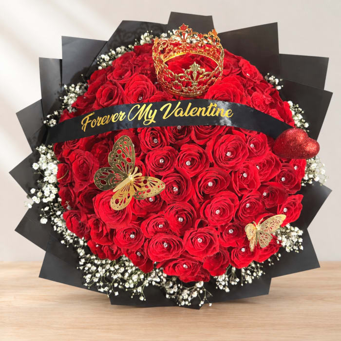 Red rose bouquet with a crown topper and black wrap