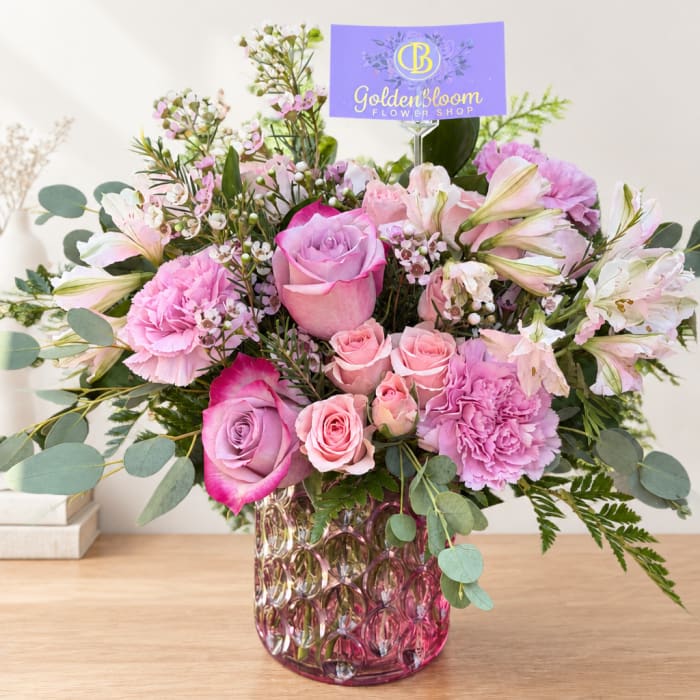 Pink and lavender bouquet in a patterned glass vase