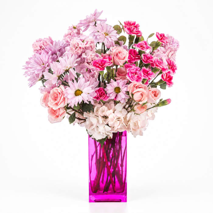 Pink mixed bouquet in a tall magenta vase