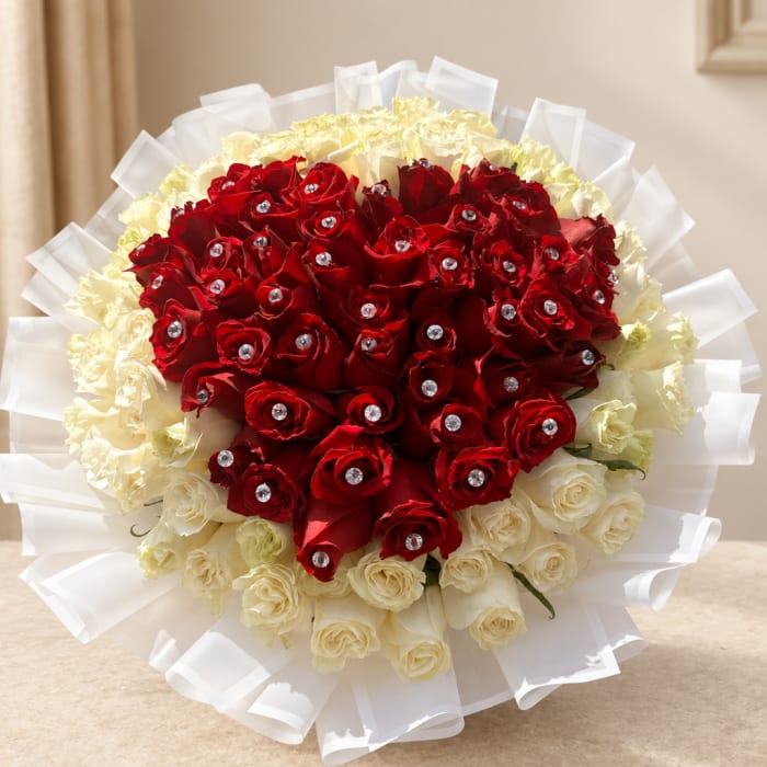 Bouquet of red and cream roses wrapped in white paper