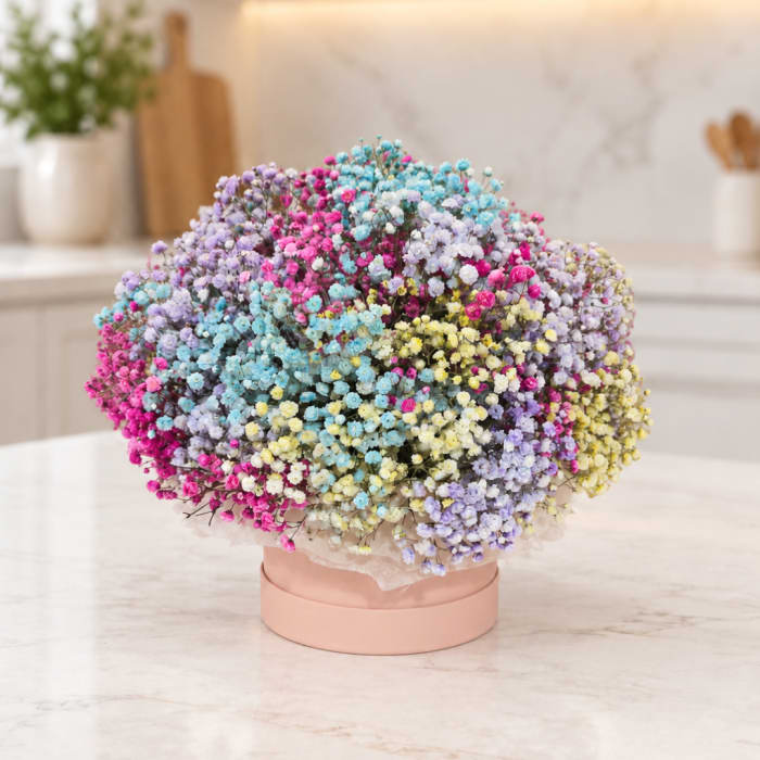 Round bouquet of pastel baby’s breath in a pink box