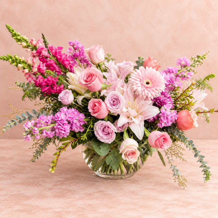 Pink and lavender mixed bouquet in a clear glass vase