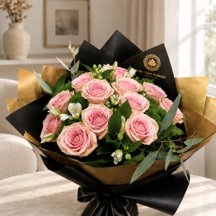 Bouquet of pink roses wrapped in black and gold paper