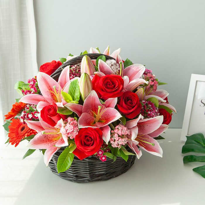BASKET OF PINK LILIES AND RED ROSES