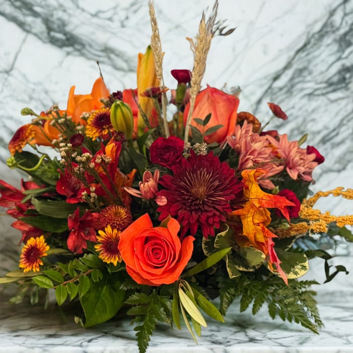 Autumn bouquet with orange roses and burgundy chrysanthemums