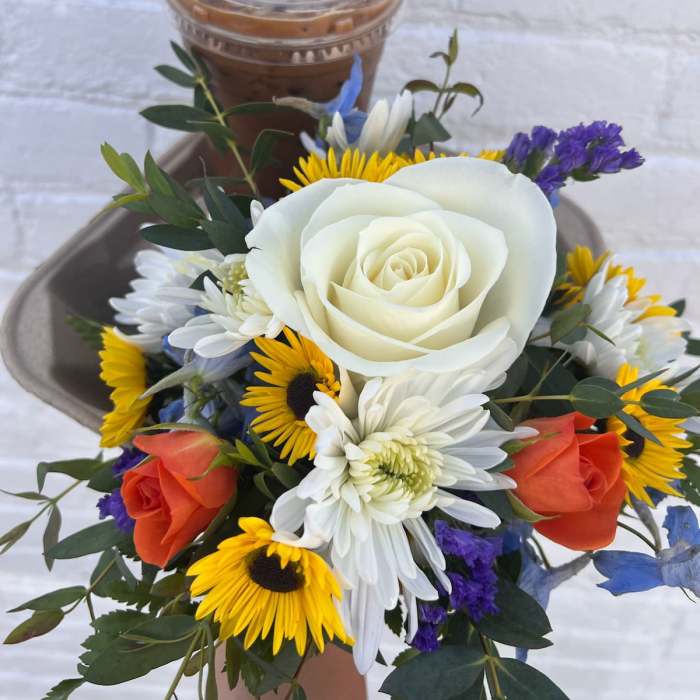 Bouquet with white and orange roses, yellow daisies, and purple filler flowers