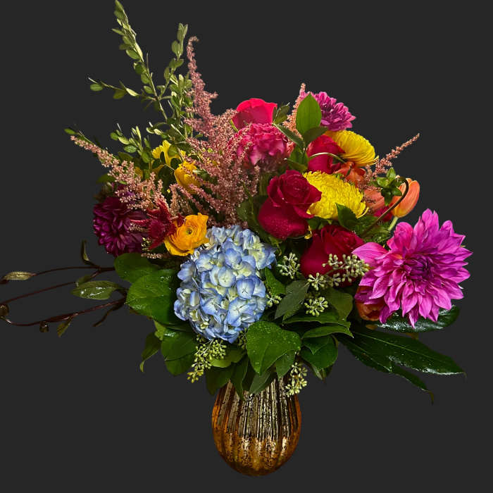 Colorful mixed bouquet in a gold vase with hydrangea and dahlias