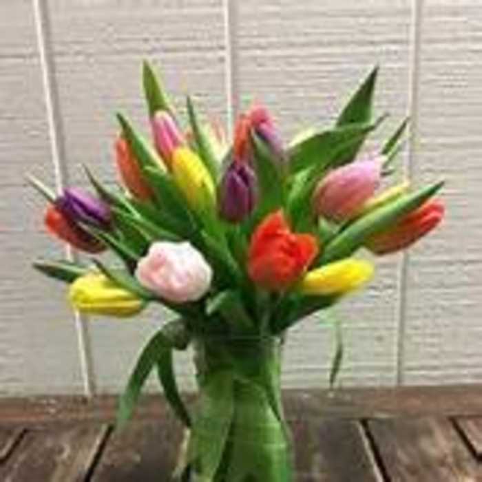 Colorful tulips arranged in a clear glass vase