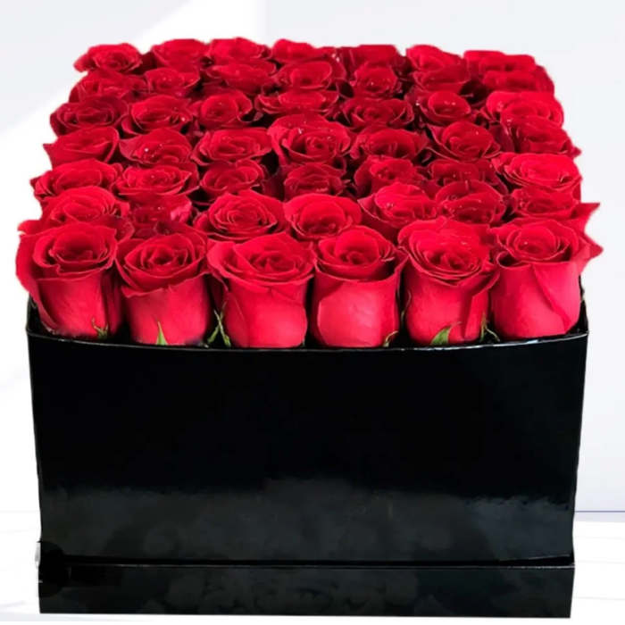 Box of red roses in a black square container