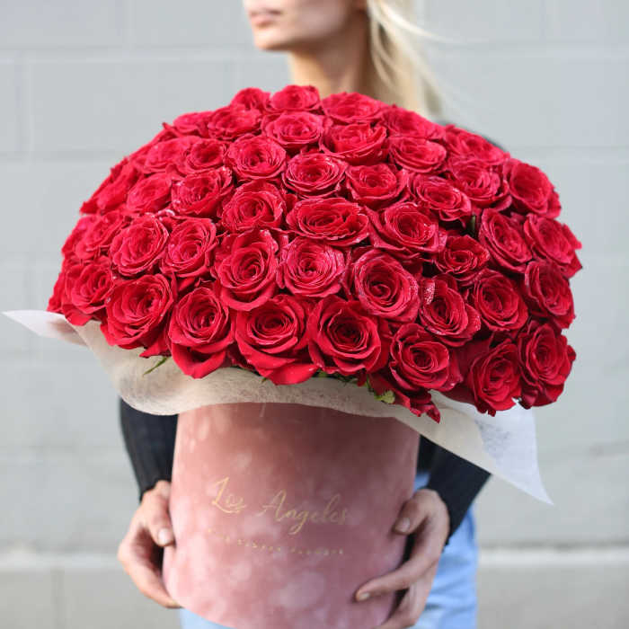 Large bouquet of red roses wrapped in pink paper