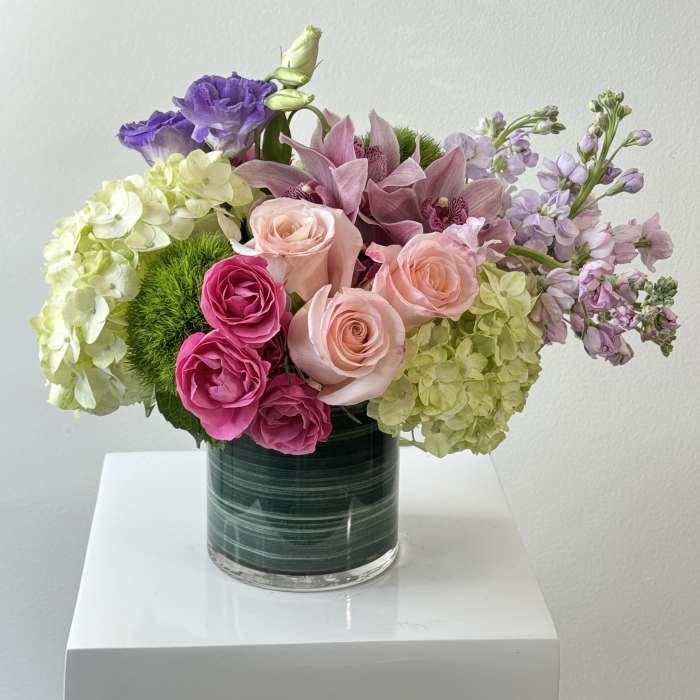 Mixed pink and purple bouquet in a glass vase