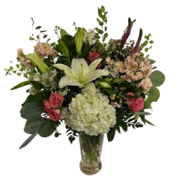 Bouquet of lilies, hydrangea, and pink flowers in a glass vase