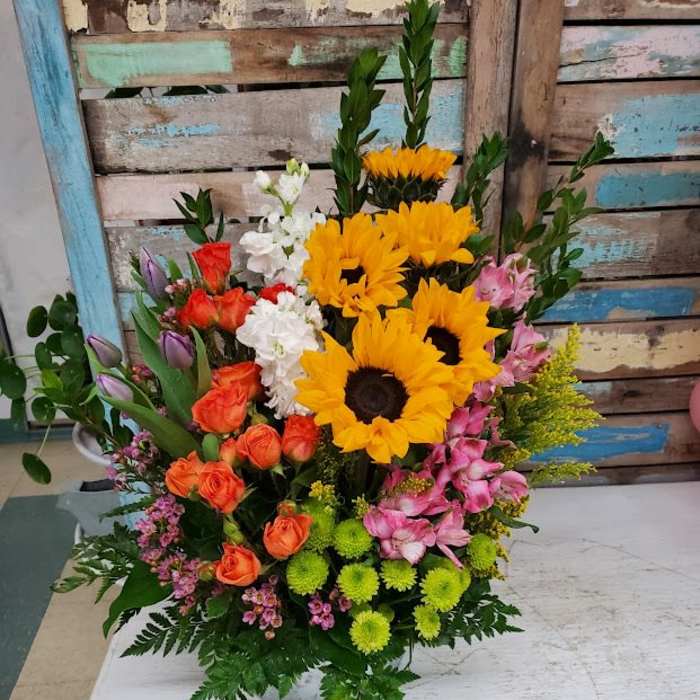 Mixed bouquet with sunflowers, roses, and alstroemeria in a vase