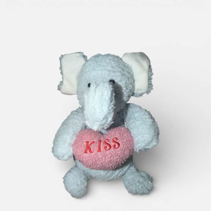 Plush elephant holding a pink heart with the word KISS