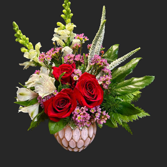 Red roses and white snapdragons in a decorative vase