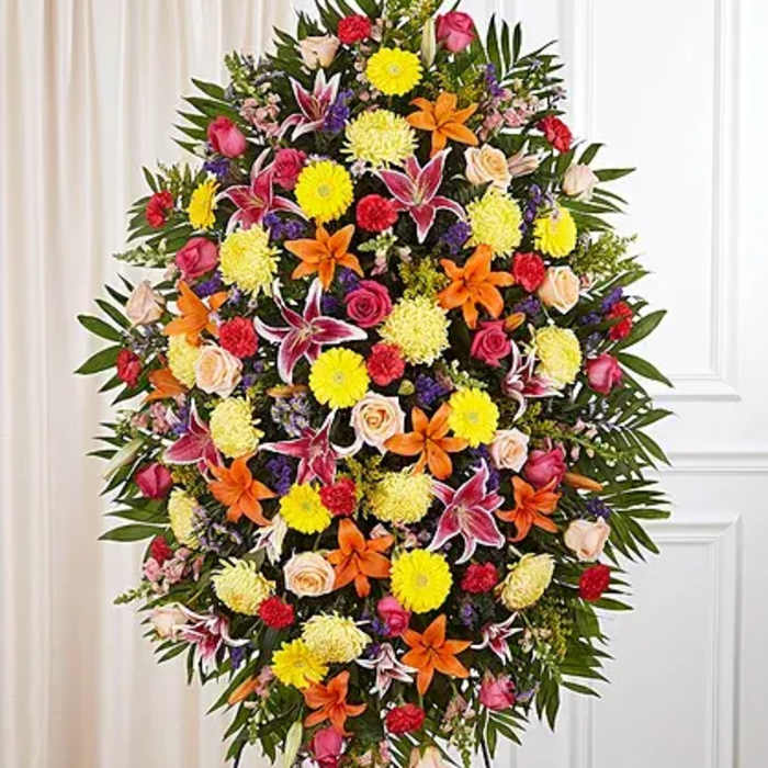 Large standing spray of mixed flowers in bright colors
