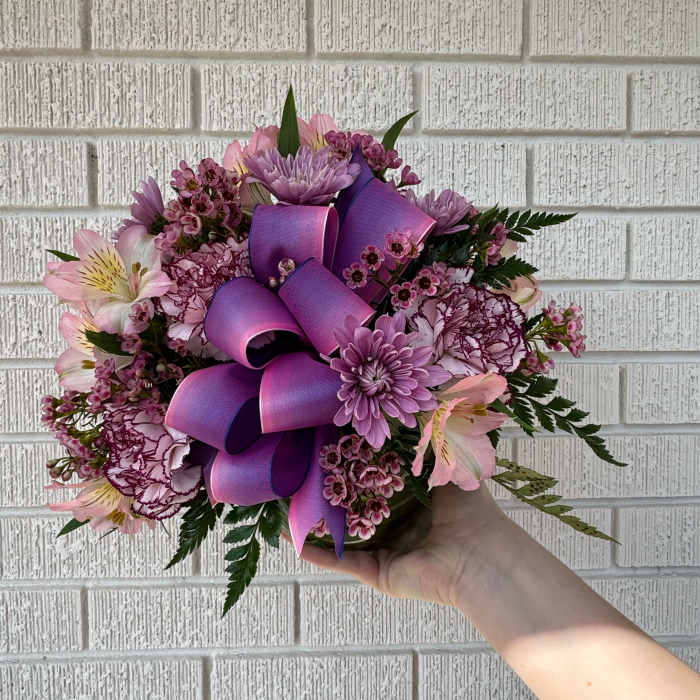 Pink and purple bouquet with a large ribbon bow