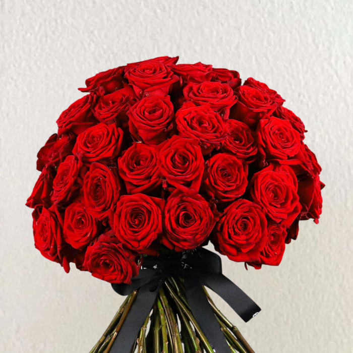 Bouquet of red roses tied with a black ribbon
