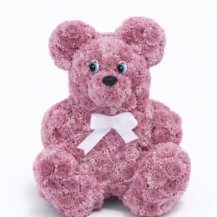 Pink flower teddy bear with a white bow