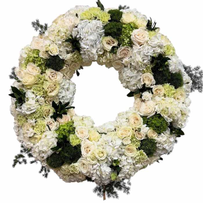 Circular wreath of white and cream flowers with green accents