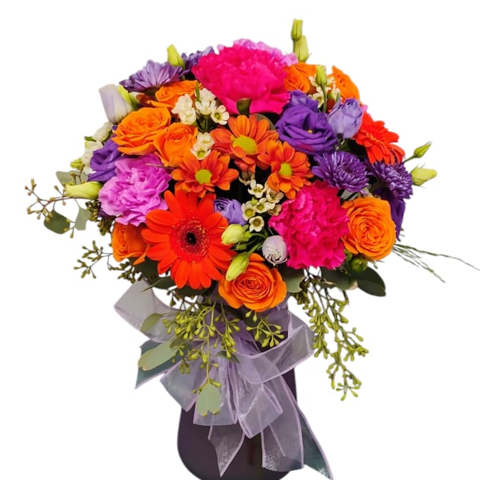 Bright mixed bouquet in a dark vase with orange, pink, purple, and red flowers