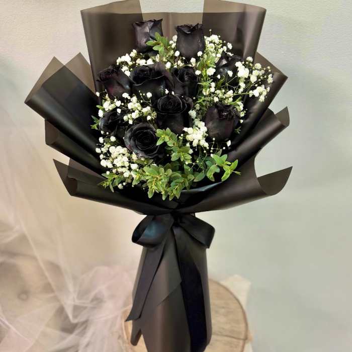 Bouquet of black roses with white baby's breath in black wrap