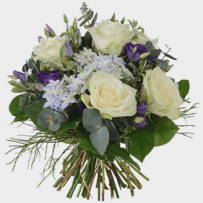Bouquet of white roses and purple flowers with mixed greenery